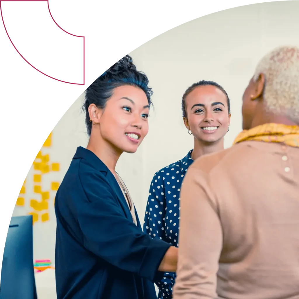 A group of 3 people engage in conversation